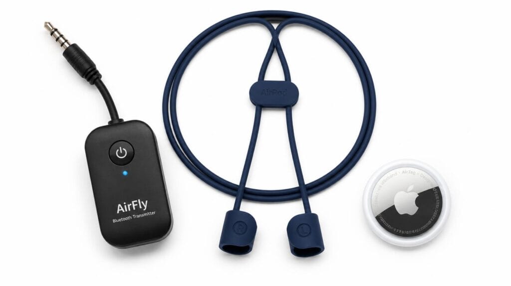 A Bluetooth transmitter, a silicone AirPod strap, and an Apple AirTag tracker arranged on a white background
