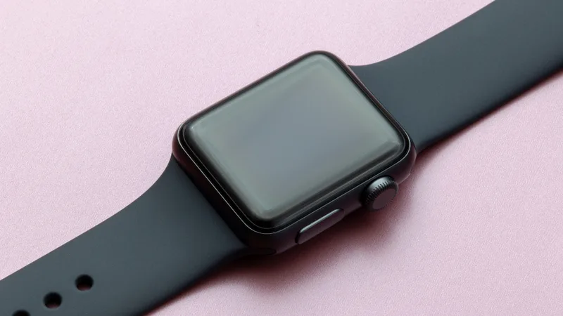A smartwatch on a pink surface