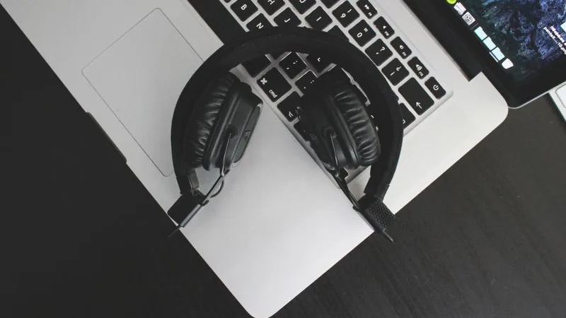 Headphones resting on an open laptop