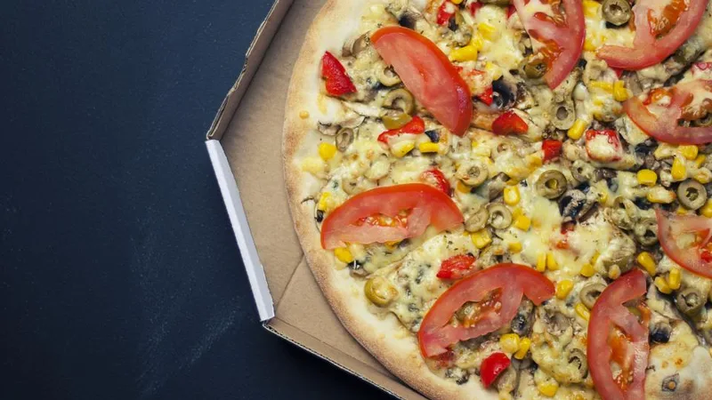 A pizza in a delivery box