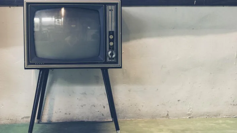 A vintage television set against a wall
