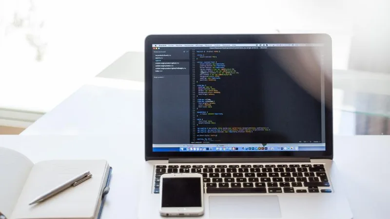 Laptop, notebook and pen on a desk