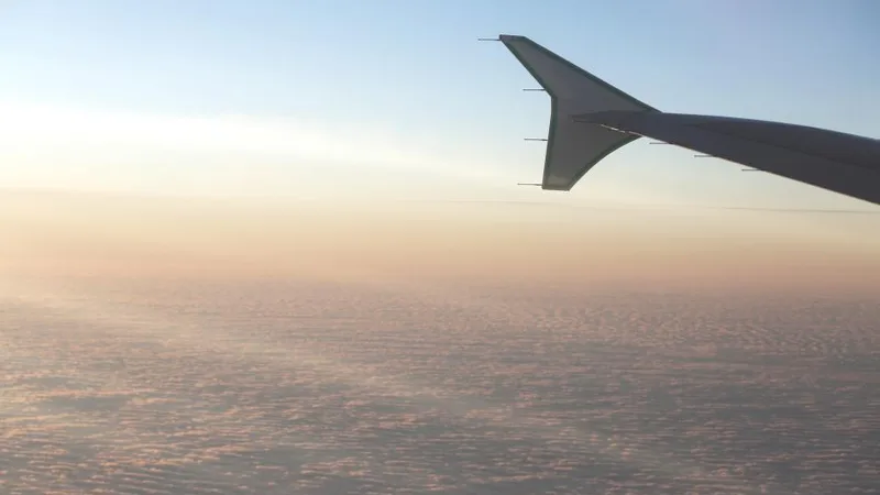 An airplane wing above the clouds