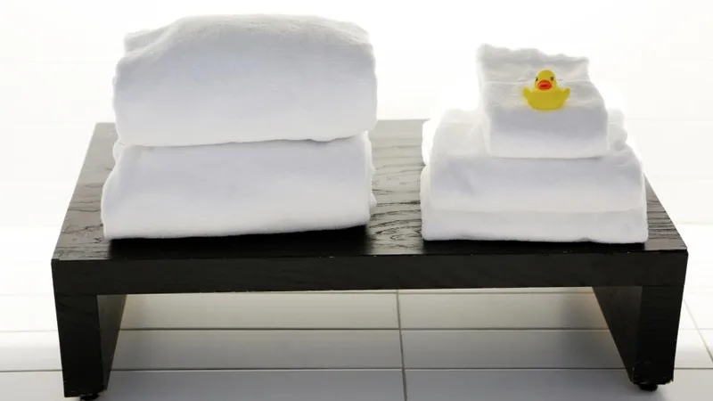 Folded spa towels and a candle