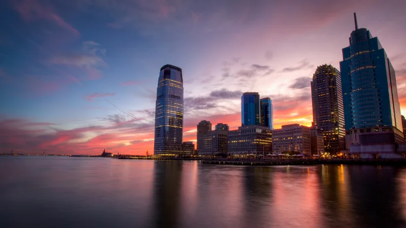 A city skyline lit up at dusk