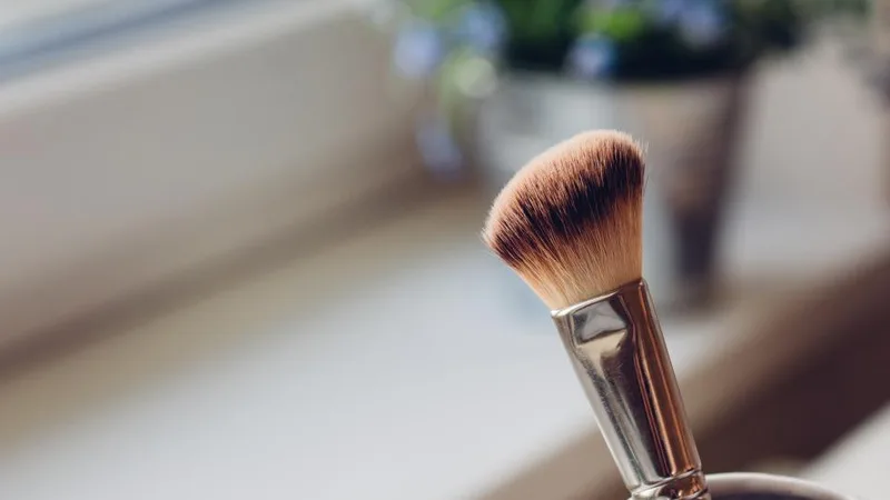 A makeup brush in a cup