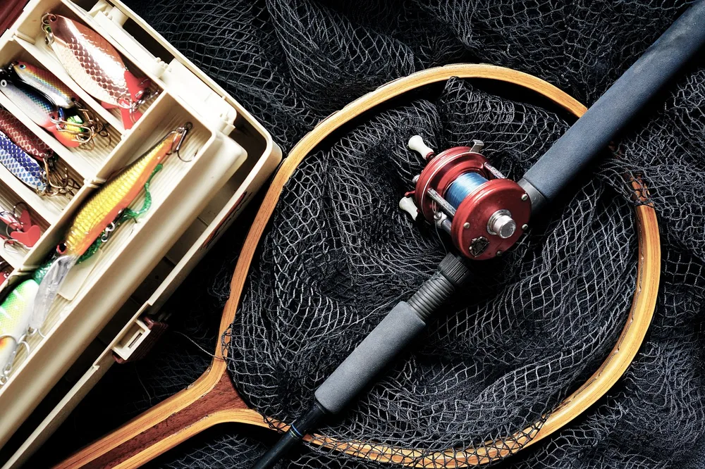 Fishing rod and reel with a landing net
